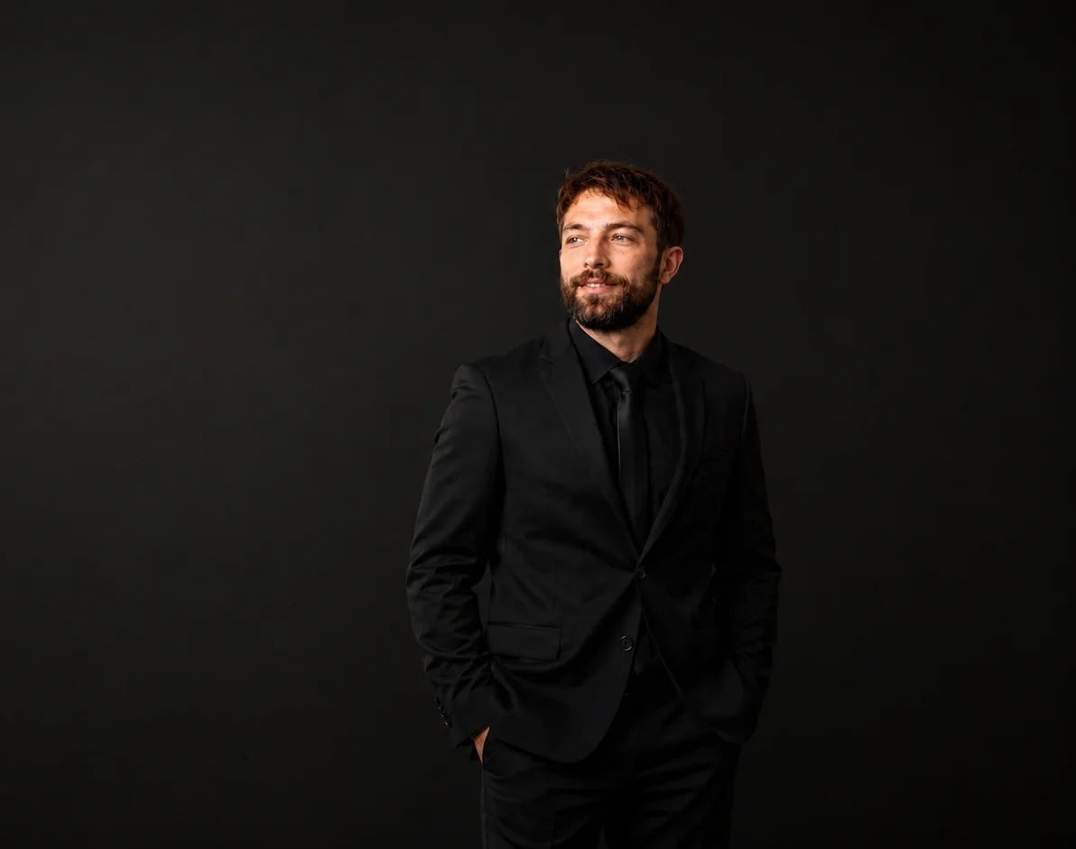 Joel Newport, owner of Code With Power, in a dark studio portrait